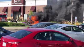 Car explodes in a parking lot, burns to the ground, firefighters put it out