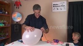Young boy laughs hilariously when balloons are popped