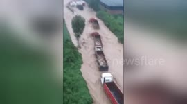 Dozens of lorries get trapped in flash floods