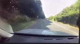 Boy cyclist nearly being run over while crossing busy road