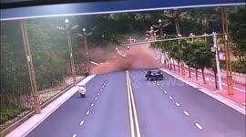 Terrifying moment when a massive landslide buries 3 vehicles