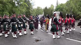 Highlanders march through manure greeting Queen at Balmoral
