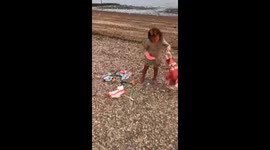 Little girl picks up litter after tourists from Southend beach