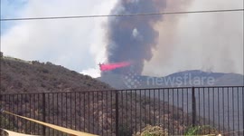 Incredible video shows small spotter plane guiding huge air tanker in Holy Fire air attack