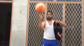 Ace basketballer changes T-shirt while spinning ball on his finger