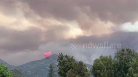 Cloud of red fire retardant hovers over mountain in Holy Fire fight