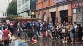 Newsflare Edit - Londoners make bridge from chairs to cross giant puddle