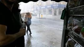 Torrential rain batters pedestrians in London