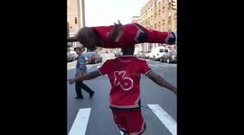 Man spins on twin brother's head in amazing workout stunt