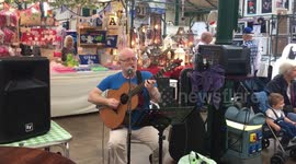 Busker entertaining the crowds at an indoor market in Belfast