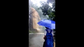 Water cascades down mountainside during Philippines floods