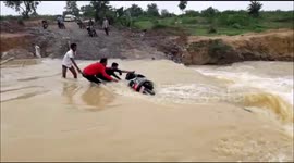 Video shows rushing floodwaters washing away locals' motorcycle in north India