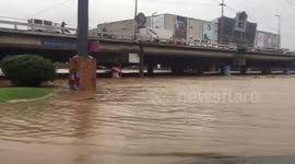 Road flooded after river bursts its banks in Philippines monsoon downpours