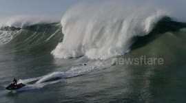 Big Wave Surfer At Nazaré Misses His Jet Ski Tow, Gets Hit Full Force By Massive Wave (Raw Footage)