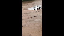 Camper van floats down overflowed Fishing Creek