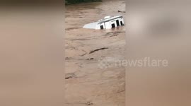 Camper van floats down overflowed Fishing Creek