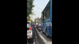 Moped riders lift their bikes over barrier to dodge bus lane fine