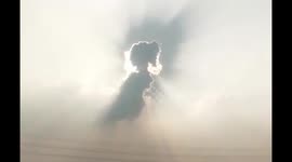 Cloud shaped like a girl above town