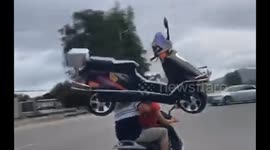 Real or fake? Man on motor scooter appears to carry another scooter