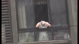 Chinese man uses falling rain to wash his hair
