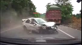 Driver thrown out of car after collision with 2 trucks