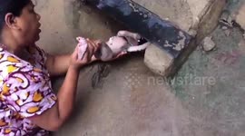 Incredible moment woman rescues baby which was dumped in storm drain