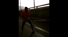 Man dancing breakdance on the freeway