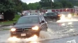 Cars slosh through floodwaters in Madison