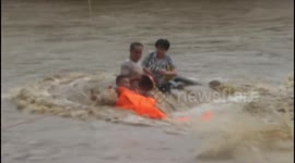 Firefighters rescue couple trapped on minivan in flash floods