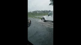 Cars navigate through flooded streets in Madison