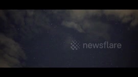 bright Iridium satellite flare illuminates cloud