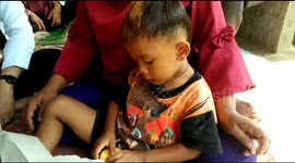 Smoking toddler from Indonesia kicks habit for a year's supply of biscuits and milk
