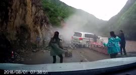 Mountainside collapses, almost shunting family car into river in China's Sichuan