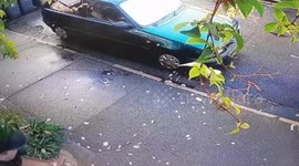 An angry nan was caught on CCTV battering a burglar in the street after she caught him raiding her home