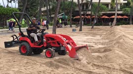 Worker uses bulldozer to build sand wall in Waikiki ahead of Hurricane Lane landfall