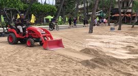 Worker uses bulldozer to build sand wall in Waikiki ahead of Hurricane Lane landfall