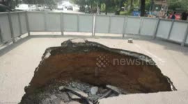 Huge sinkhole opens up after truck drives along road