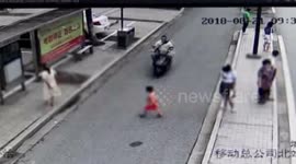Scooter rider playing on phone crashes into boy