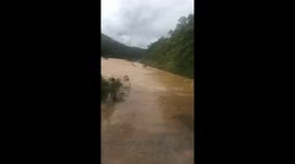 The men carrying the motorbike crossed the flood water