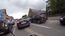 Dog driving car on drivers knee