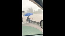 Man seen fishing as Hurricane Lane dumps sheets of rain on Hawaii