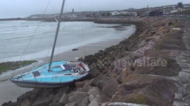 Man and two dogs rescued as Yacht swept onto rocks in storm