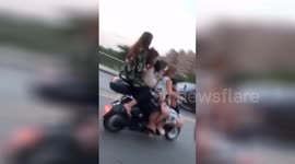 Five women seen balancing precariously on scooter in southern Chinese province
