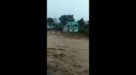 Two-storey house swept away by raging flood waters