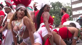 Three girls are dancing at Notting Hill Parade 2018 in London