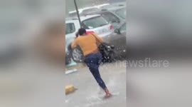 Girl yanks off new wig in heavy downpour before making hilarious dash for car