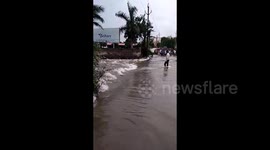 Motorbike rider is swept away by floods in India