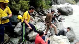 In the Himalayas, a rescue worker zip lined across a flooded river to pull out a horse