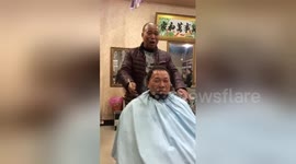 Chinese barber uses angle grinder to cut hair