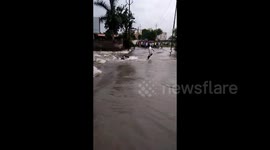Motorbike rider is swept away by floods in India